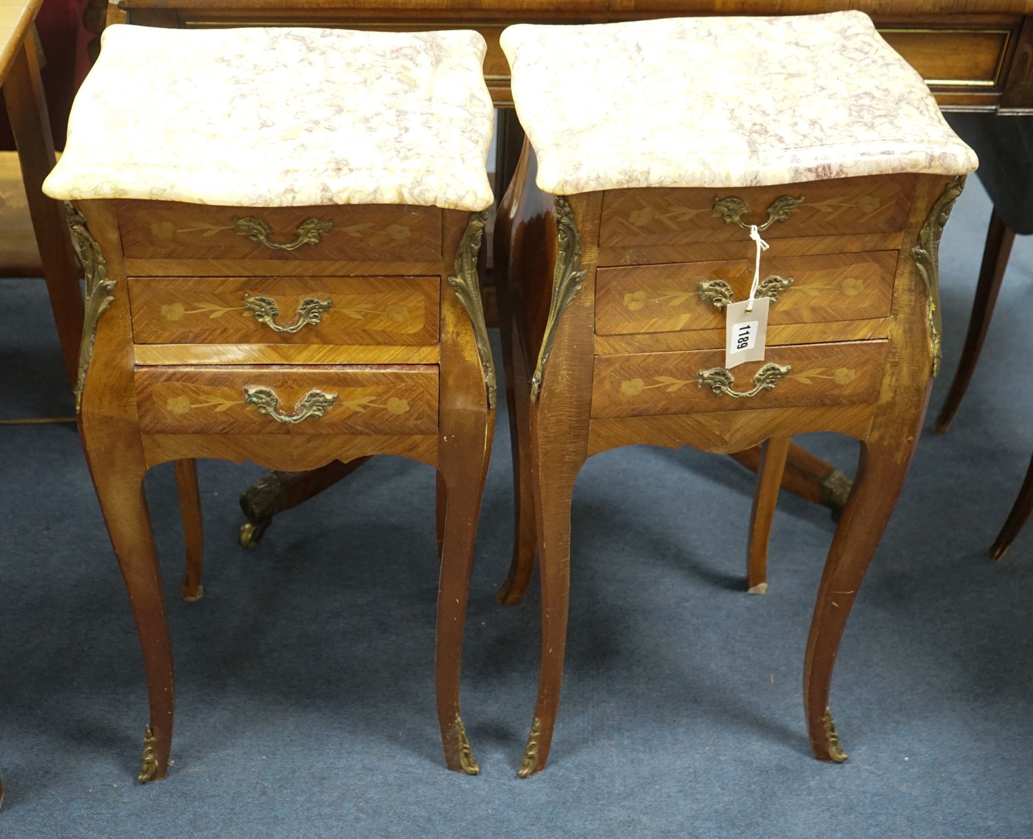 A pair of Louis XVI design marquetry inlaid, gilt metal mounted serpentine bedside chests, width 34cm, depth 29cm, height 73cm